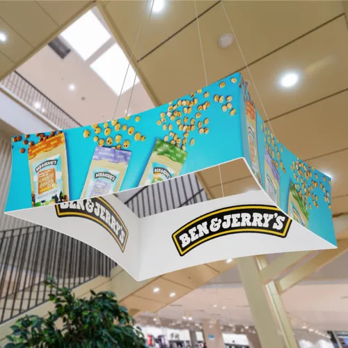 A hanging promotional display featuring 'Ben & Jerry's' branding is suspended in an indoor shopping area.